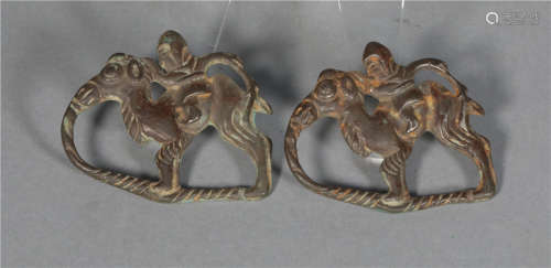 A pair of silver men riding camels in the Tang Dynasty