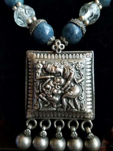 A Silver Carved Character Pendant