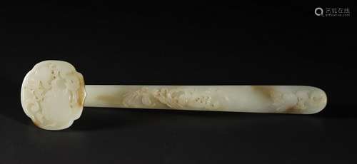 A PALE CELADON/RUSSET JADE CARVING OF A RUYI SCEPTER