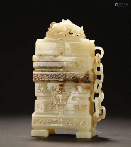 A PALE CELADON/RUSSET JADE CARVING OF BOX AND SEALS