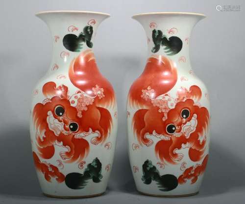 PAIR OF IRON RED VASES/LIONS