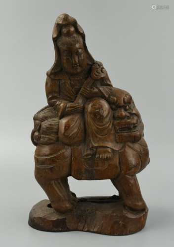 A Wood Carving of Guanyin Upon a Buddhist Lion