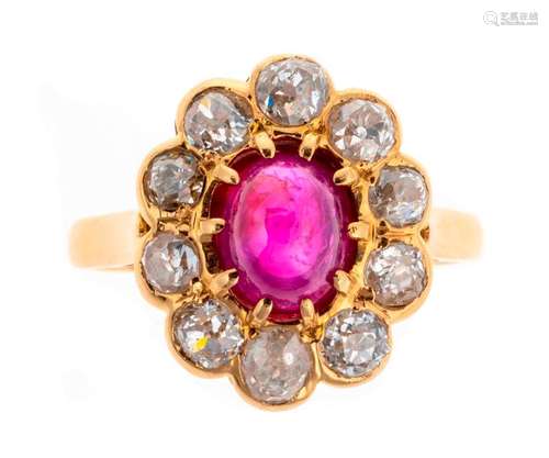 Gold ring set with a ruby cabochon in a brilliant …