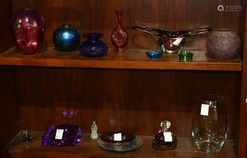 Two shelves of mostly art glass