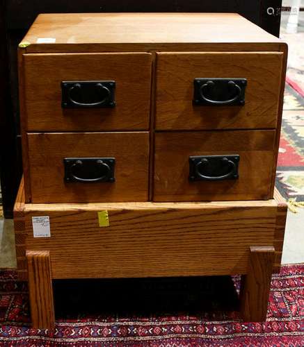 Mission style oak four drawer file cabinet on an