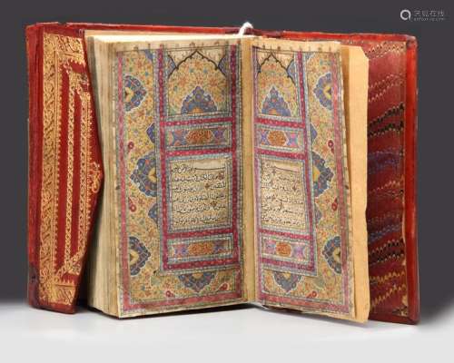 A SMALL RED LEATHER BOUND QURAN