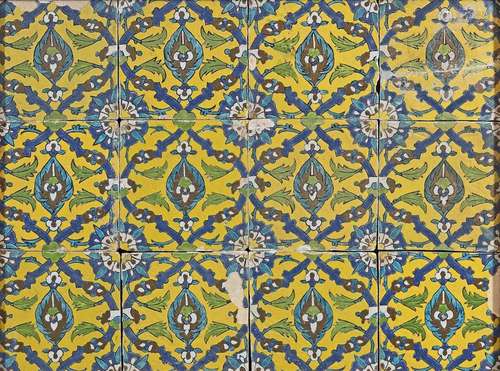 TWELVE YELLOW GROUND SAFAVID TILES MOUNTED IN A FR…