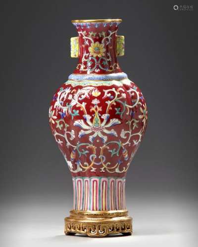 A CHINESE RUBY GROUND FAMILLE ROSE WALL VASE