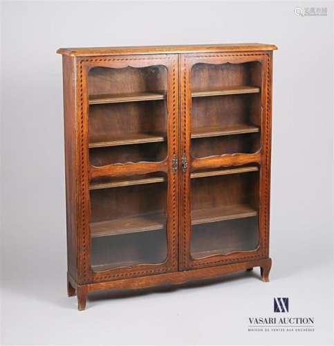 A walnut and veneer display case, it opens on the …