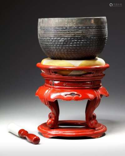 A JAPANESE TEMPLE BELL ON RED LACQUERED STAND WITH…