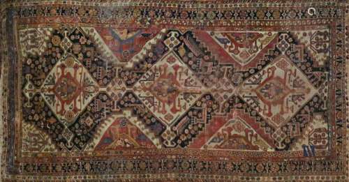 Wool carpet decorated with three rhombuses on a be…