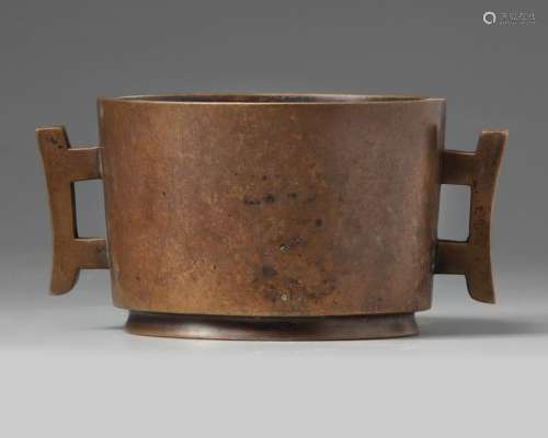 A CHINESE BRONZE TWIN HANDLED CENSER