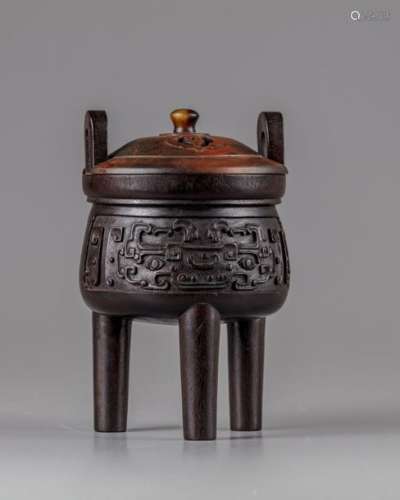 A CHINESE HARDWOOD ARCHAISTIC TRIPOD CENSER AND CO…