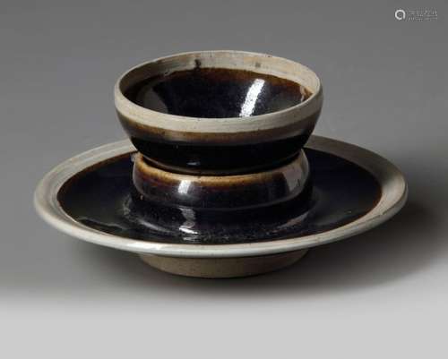 A CHINESE BLACK GLAZED CUP AND CUP STAND
