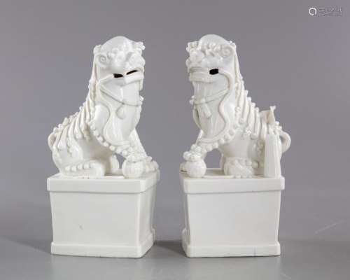 A PAIR OF CHINESE BLANC DE CHINE BUDDHIST LIONS