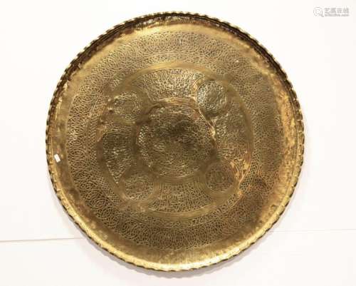 A BRASS CIRCULAR CARVED TRAY