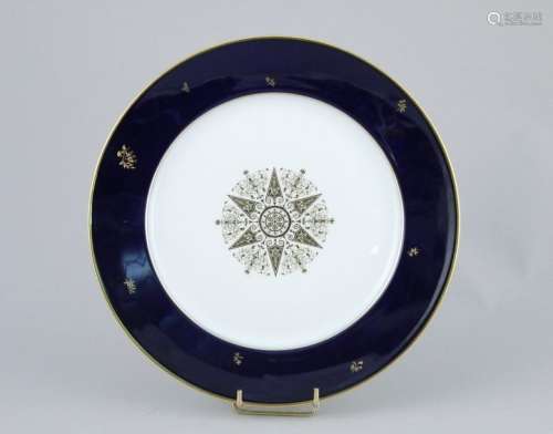 SEVERED. Porcelain plate with a golden rosette, th…