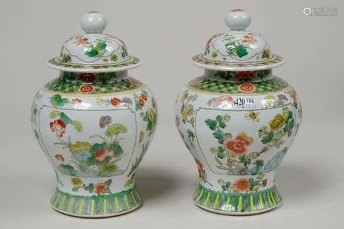 Pair of small polychrome porcelain vases with flor…