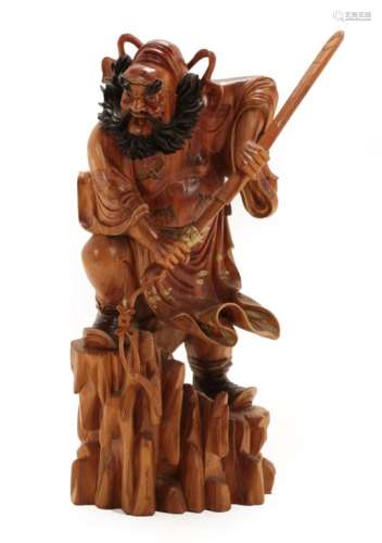 A Chinese Gilt Painted and Lacquered Wood Figure of Zhong Kui, late Qing, standing on a rocky