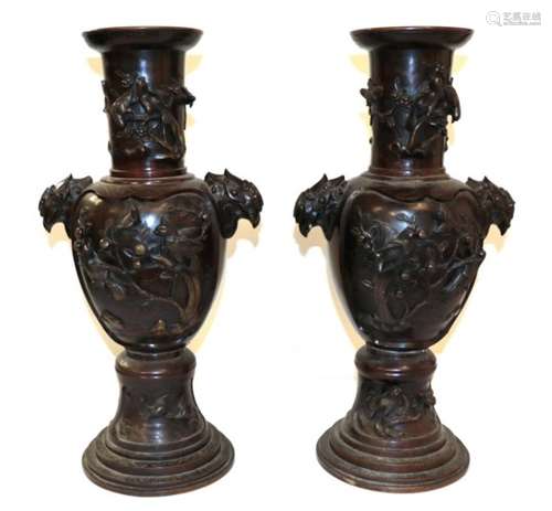 A Pair of Japanese Bronze Vases, Meiji period, of baluster form with trumpet necks and mask handles,