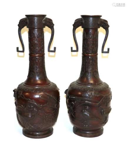 A Pair of Japanese Bronze Bottle Vases, Meiji period, with mask and loop handles on stiff leaf