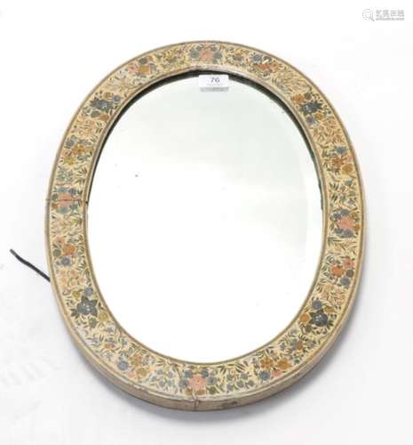 An Indian Painted Wall Mirror, late 19th/early 20th century, of oval form with foliate decoration,