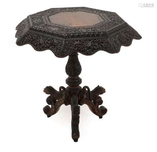 An Indian Carved Hardwood Centre Table, probably Bombay, late 19th century, the hexagonal tip-top