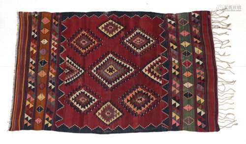 Anatolian Kilim, circa 1950 The brick red field centred by a latch hook medallion surrounded by