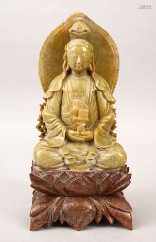 A 20TH CENTURY CHINESE CARVED SOAPSTONE FIGURE OF GUANYIN, in a seated position holding a vase and