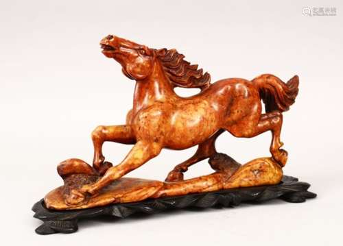 A 19TH / 20TH CENTURY CHINESE CARVED SOAPSTONE FIGURE OF A HORSE, the horse in a galloping pose