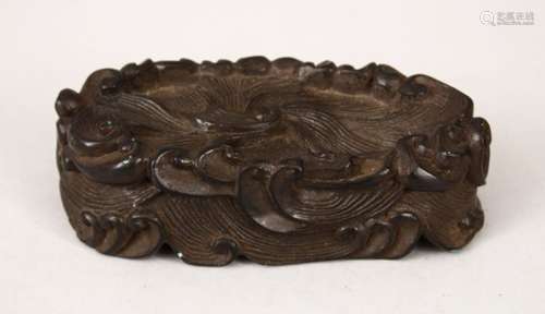 A 19TH CENTURY CHINESE CARVED HARDWOOD WAVE STAND, carved in the form of crashing waves, 12cm wide x