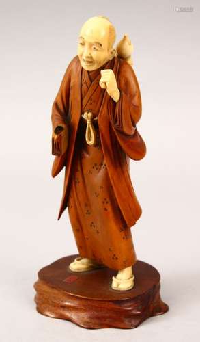 A JAPANESE MEIJI PERIOD CARVED WOOD & IVORY OKIMONO OF A MAN, the man stood with a double ourd