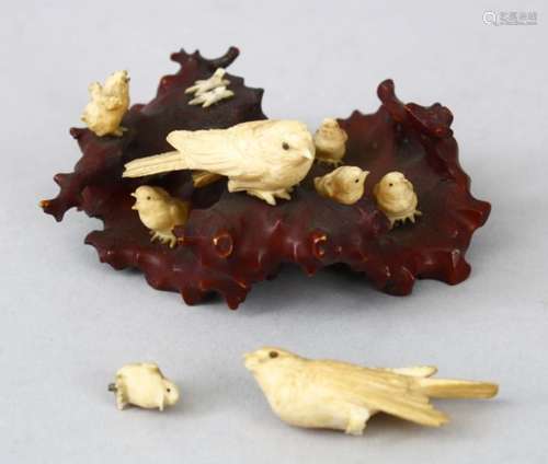 A JAPANESE MEIJI PERIOD CARVED WOOD AND IVORY BIRD OKIMONO GROUP, the carved stylized timber outcrop