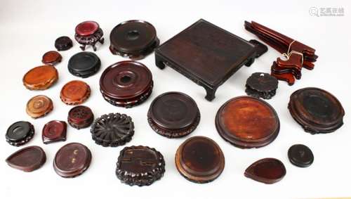 A MIXED LOT OF 28 19TH / 20TH CHINESE HARDWOOD STANDS, 25 various shaped carved and pierced hardwood