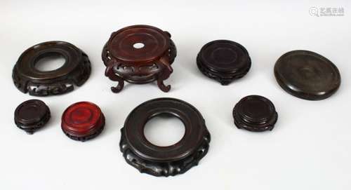 A MIXED LOT OF EIGHT 19TH CENTURY CHINESE CARVED HARDWOOD STANDS, various shapes, timbers and sizes.