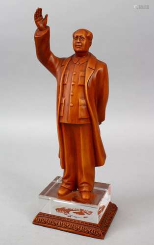 A 20TH CENTURY CHINESE CARVED HARDWOOD FIGURE OF MAO ZEDONG, stood with his hand aloft, upon a glass