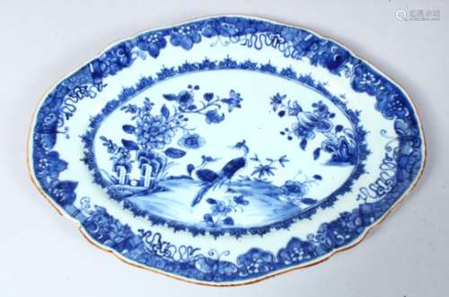 A 19TH CENTURY CHINESE BLUE & WHITE PORCELAIN SERVING DISH, decorated with peacocks amongst native