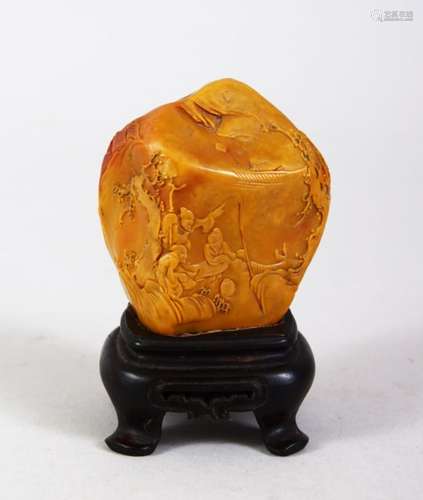 A GOOD CHINESE CARVED SOAPSTONE FIGURE & HARDWOOD STAND, the carving depicting scenes of immortals