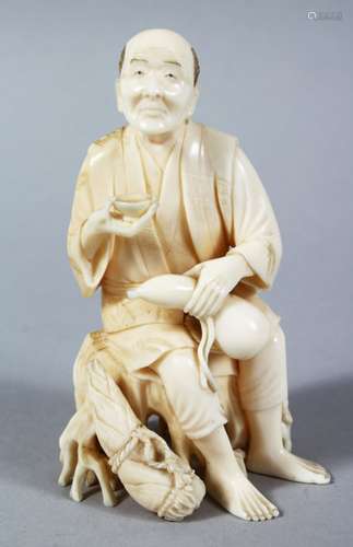 A GOOD JAPANESE MEIJI PERIOD CARVED IVORY OKIMONO - MAN DRINKING SAKE, the figure seated upon a