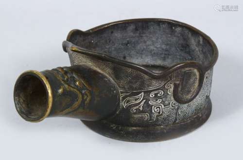 A GOOD EARLY CHINESE BRONZE SILK IRON, the body decorated with archaic design, 20cm wide.