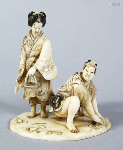 A GOOD JAPANESE MEIJI PERIOD CARVED IVORY OKIMONO - SHELL COLLECTORS, the male and female figure