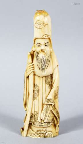 A JAPANESE LATE MEIJI PERIOD CARVED IVORY OKIMONO OF FUKUROKUJU, stood holding an uwicha fan and a