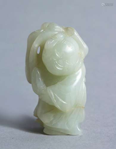 A GOOD CHINESE POSSIBLY 16TH / 17TH CENTURY CELADON JADE CARVING OF A BOY, the boy bearing a grin