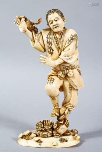 A GOOD JAPANESE MEIJI PERIOD CARVED IVORY OKIMONO OF A FISHERMAN & CRABS, the fisherman stood