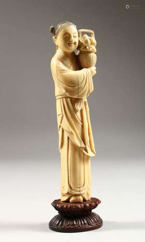 A GOOD 19TH CENTURY CHINESE CARVED IVORY FIGURE OF A FRUIT SELLER, the lady stood holding a basket