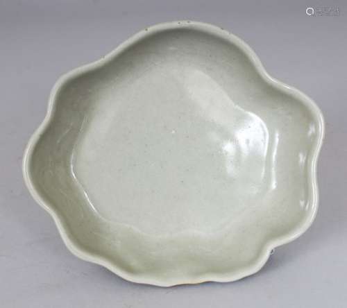 AN UNUSUAL CHINESE CELADON GLAZED PORCELAIN BRUSH WASHER, with a wavy rim, the base unglazed, 12.9 x