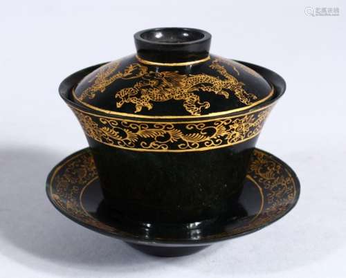 A GOOD 19TH / 20TH CENTURY CHINESE CARVED SPINACH GREEN & GILT DRAGON JADE TEA BOWL, COVER & SAUCER,