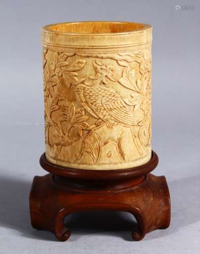 A 19TH CENTURY CHINESE CANTON CARVED IVORY CYLINDRICAL BRUSH POT & STAND, the ivory pot carved to