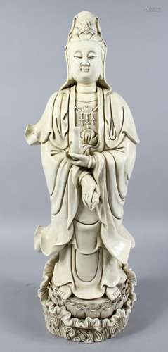 A LARGE AND HEAVY CHINESE BLANC DE CHINE / DEHUA PORCELAIN FIGURE OF GUANYIN, she is stood upon a