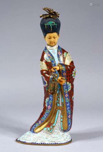 A 20TH CENTURY CHINESE CLOISONNE FIGURE OF GUANYIN, stood in traditional robes holding an object,